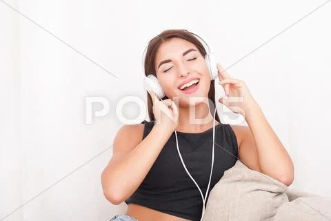 Woman listening music in headphones Stock Photos