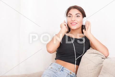 Woman listening music in headphones Stock Photos