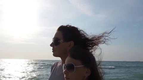 A woman with a little girl is looking at the sea. Stock Footage