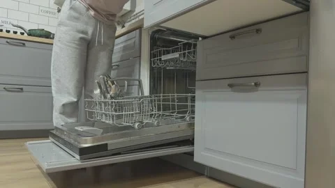 Woman Loading Dishwasher. Casually Dressed Woman In Sneakers Organizing Stock Footage 344249359