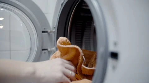 Woman loading the laundry in the washing machine slow motion Video stock 50039411