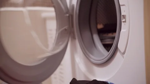 Woman loading laundry to the washing machine Video stock 101171104