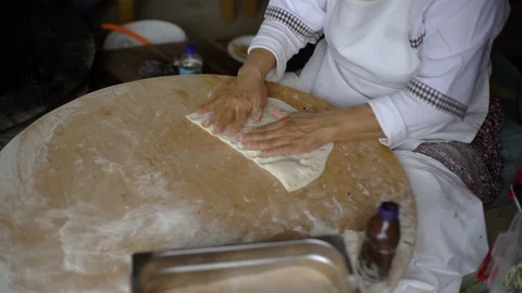 A woman is loading stuffing into a pancake, cheese, meat, potatoes. Wraps Stock Footage 91015435