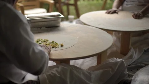 A woman is loading stuffing into a pancake, cheese, meat, potatoes. Stock-Footage 91015523