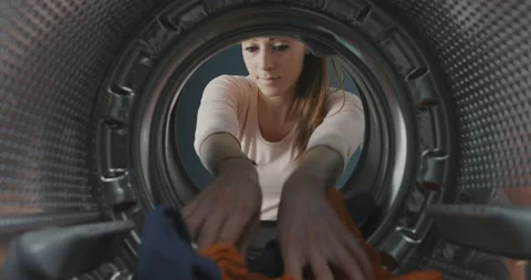 Woman loading the washing machine Stock Footage 151297094