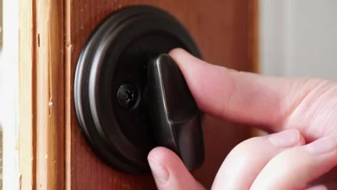 Woman locking a door security latch in slow motion Video stock 307155697