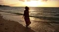 Woman in Long Dress Walking on the Beach at Sunset. Slow Motion. HD Footage