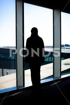 Woman looking at the airport landing ground Stock Photos