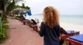 Woman Looking Beach Bungalow or Beach Resort. HD Footage