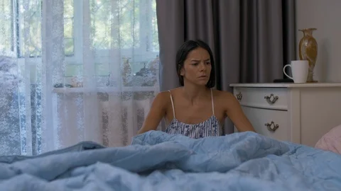 Woman looking in bed Stock Footage 115743598