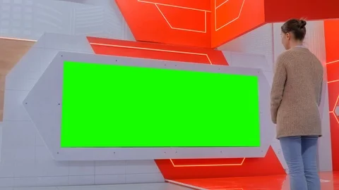 Woman looking at blank large interactive wall display - green screen concept Video stock 117287189