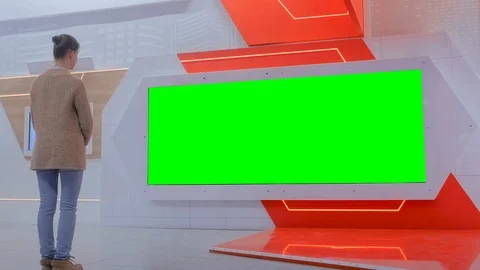Woman looking at blank large interactive wall display - green screen concept Video stock 124865251