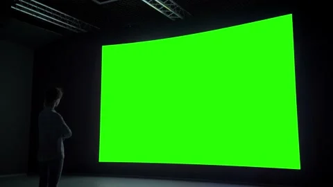 Woman looking at blank large interactive wall display - green screen concept Stock Footage 132197515