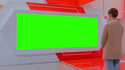 Woman looking at blank large interactive wall display - green screen concept Video stock 135054945