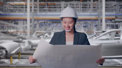 Woman Looking At Blueprint While Walking In Car Factory Stock Footage 331630906