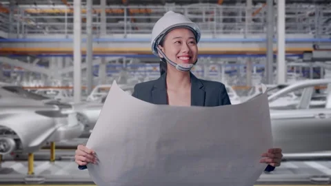 Woman Looking At Blueprint While Walking In Car Factory Stock Footage 331630914