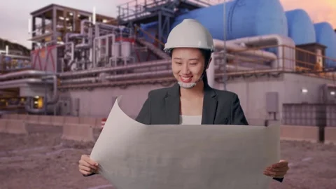 Woman Looking At Blueprint While Walking at Gas Plant Stock Footage 337759429