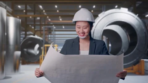 Woman Looking At Blueprint While Walking at Heavy Factory Stock Footage 340814130