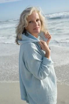 Woman looking at the camera on the beach Stock Photos