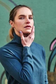 Woman looking at camera with serious expression on her face while posing Stock Photos