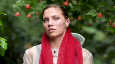 Woman looking at camera while standing near green leaves Stock Footage 161038273