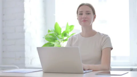 Woman Looking at Camera while using Laptop Stock Footage 204999645