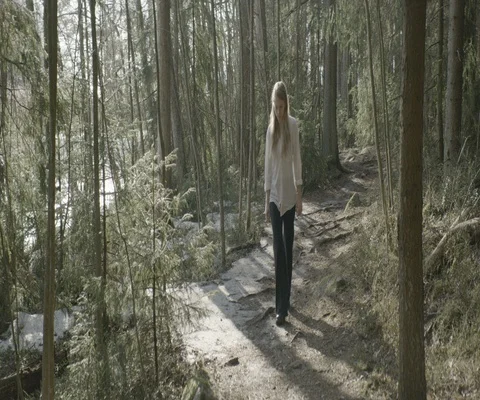 Woman looking down while walking in the forest Stock Footage 110367282