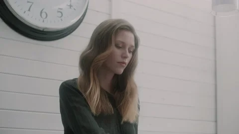 Woman looking down while working and sipping coffee Stock Footage 131048650