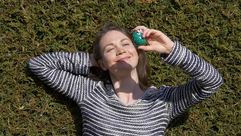 Woman looking at Easter egg with bow Stock Footage 83550693