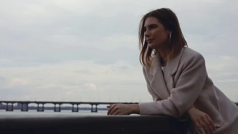 Woman looking forward at river thinking and dreaming outdoors Stock Footage 104362291