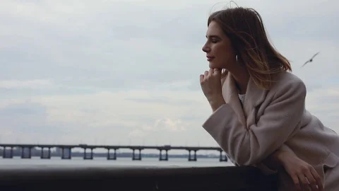 Woman looking forward at river thinking and dreaming outdoors Stock Footage 104435902