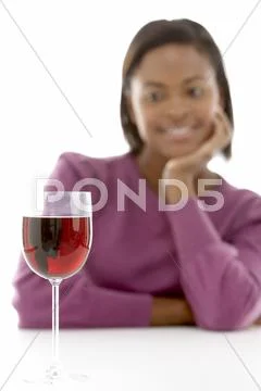 Woman Looking At Glass Of Wine Stock Photos