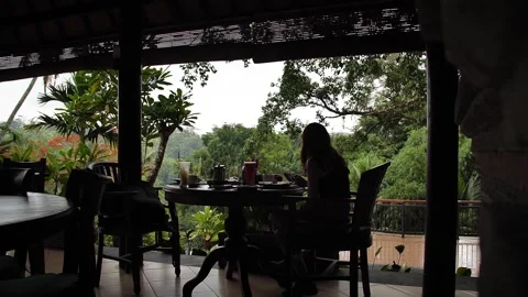 Woman looking at her phone while having breakfast at restaurant Vidéo 270129982