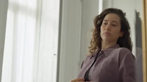 Woman looking at herself in mirror checking her clothes in the morning Stock Footage 293495398