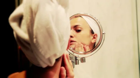 Woman looking at herself in the mirror Stock Footage