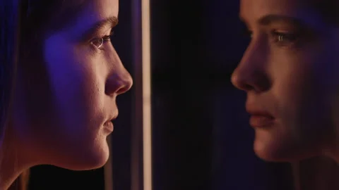 Woman Looking at Herself in Mirror Reflection. Fashion Makeup on Young Face of G Stock Footage 199480698
