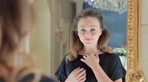 Woman looking herself reflection in mirror Video stock 66733803
