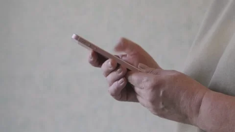 A woman is looking for information using a smartphone in her hands. Side view. Stock Footage 143654371