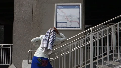 Woman-looking-at-metro-rail-map Stock Footage 99685644