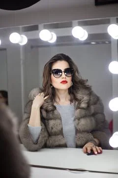 Woman looking in the mirror and applying cosmetic with a big brush. Girl ho.. Foto stock