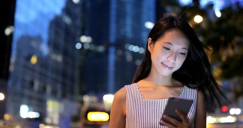 Woman looking at mobile phone in the city of Hong Kong Stock Footage