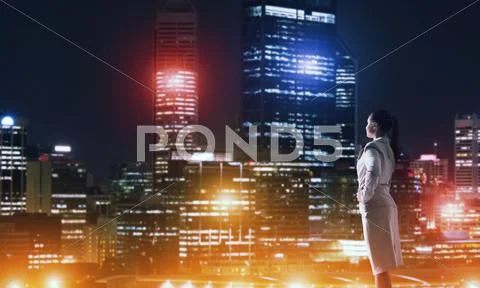 Woman looking at night city Stock Photos
