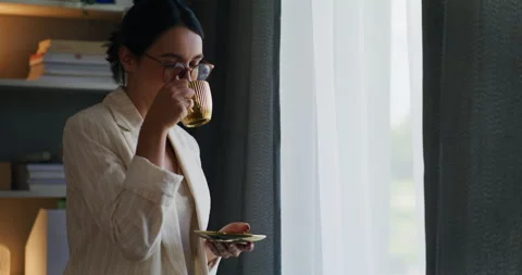 Woman Looking Out Window Drinking Tea and Happy Stock Footage 278083117