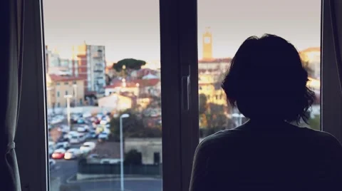 A woman looking out of a window Stock Footage