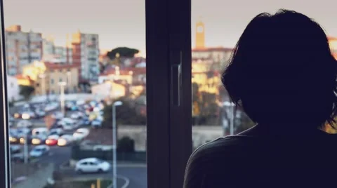 A woman looking out of a window Stock Footage 58097147