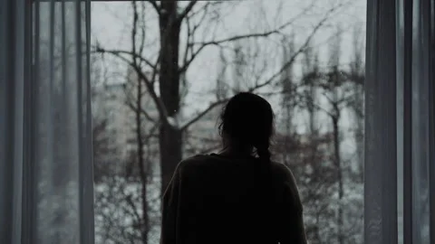 Woman Looking Out Of A Window Stock Footage 148102402