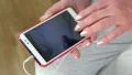 Woman looking the photos in her smartphone. Woman holding a white cell phone HD Footage