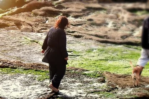 A woman looking for shells Foto stock