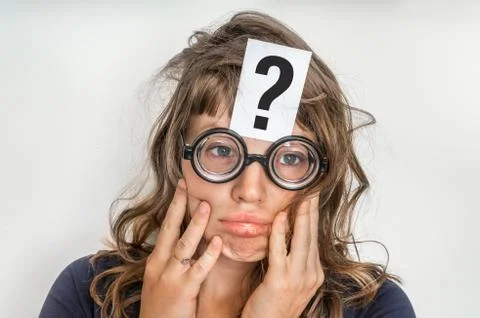 Woman is looking for a solution to the problem with question mark on paper ov Stock Photos