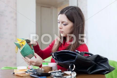 Woman looking for something in purse Stock Photos